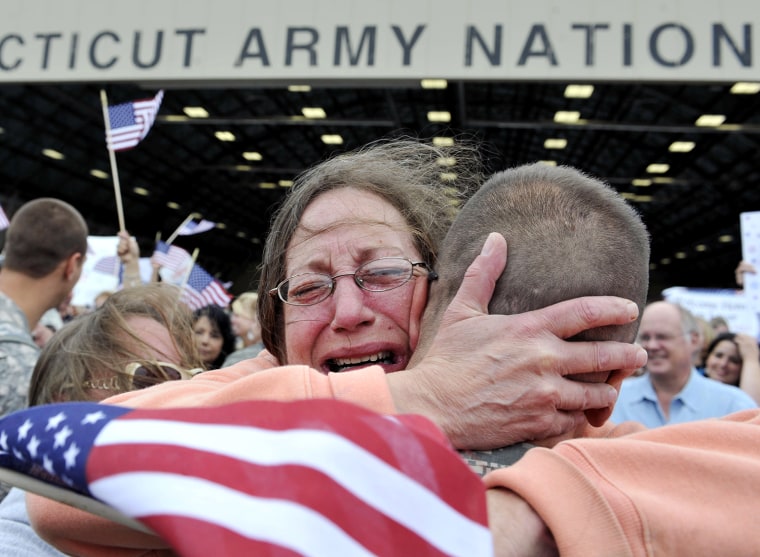 Image: Janet Allegra, of Ellington, hugs her son Spc. John Allegra IV at the Army aviation support facility in Windsor Locks, Conn.